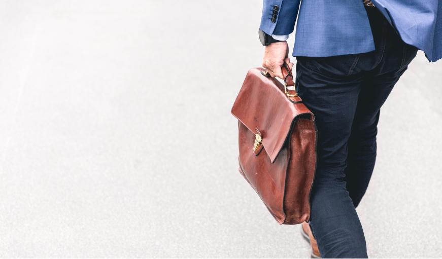 Man carrying bag walking on street 